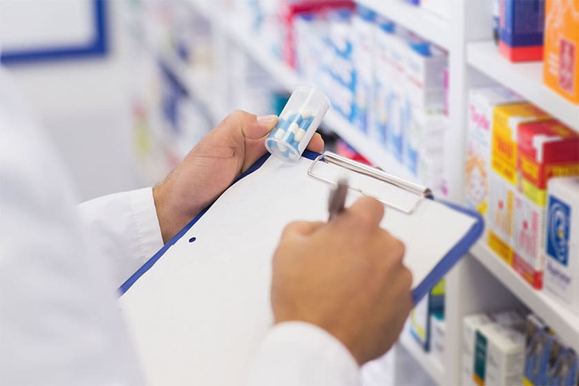 Pharmacist writing on a notepad